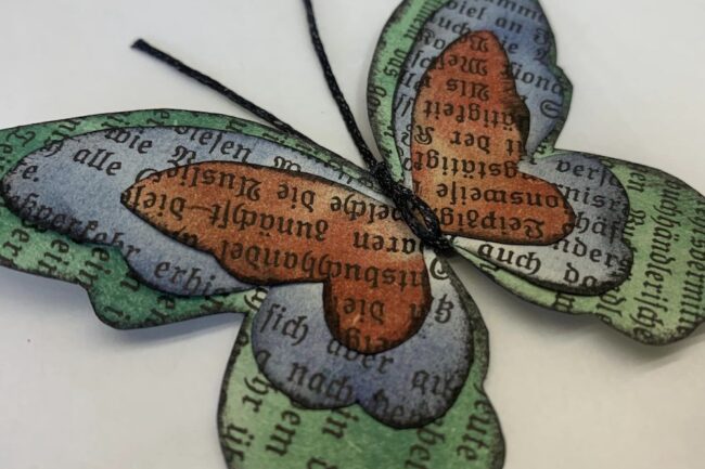 Butterflies made with fabric and paper scraps, wax thread and beads
