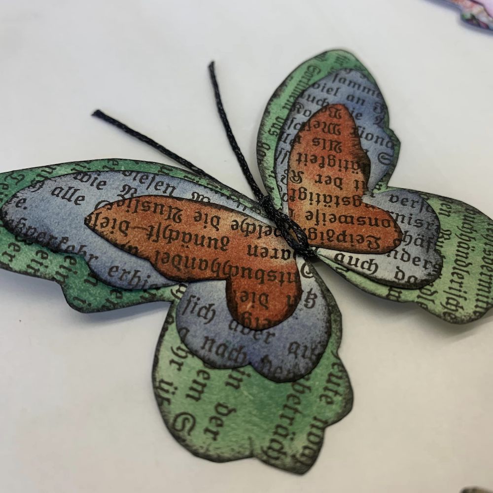 Butterflies made with fabric and paper scraps, wax thread and beads